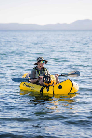 Man kayaking with dog