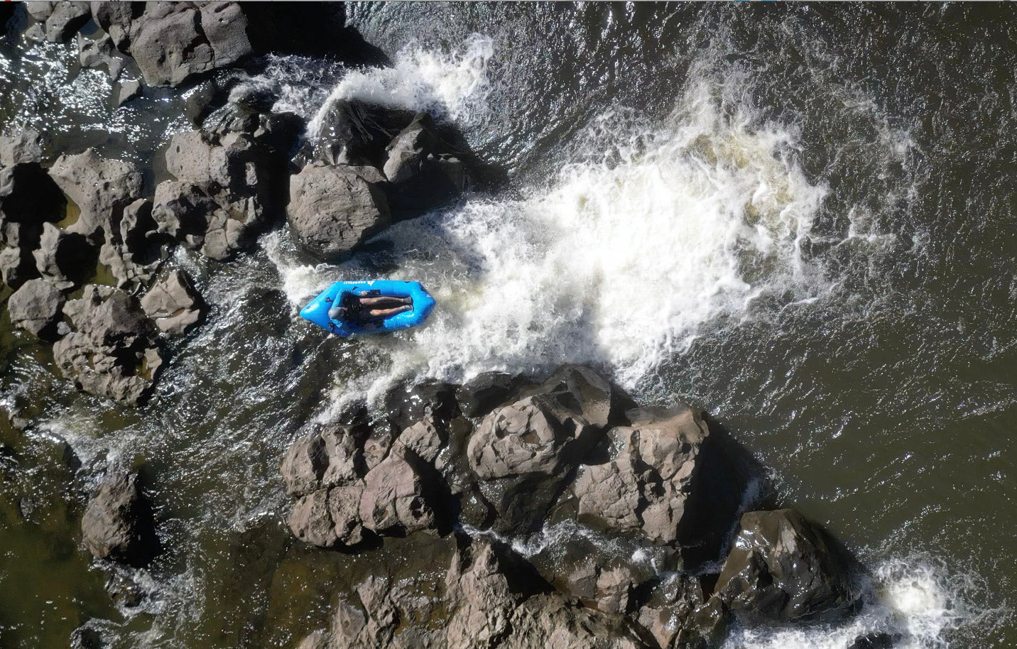 Eric Bergdoll packrafting a waterfall in Hawaii