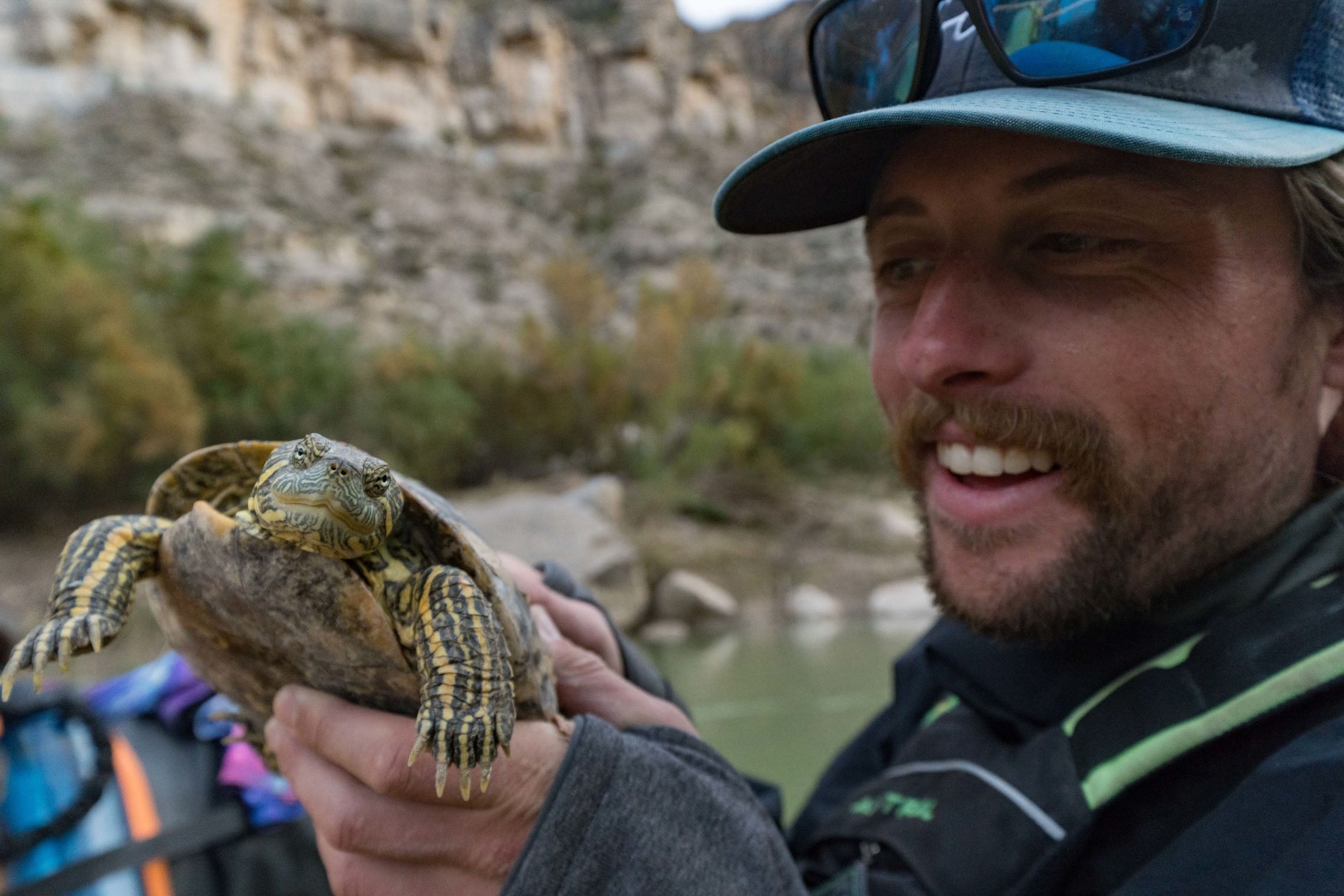 Man holding tortoise. Rio Grande Packrafting Trip Kokopelli