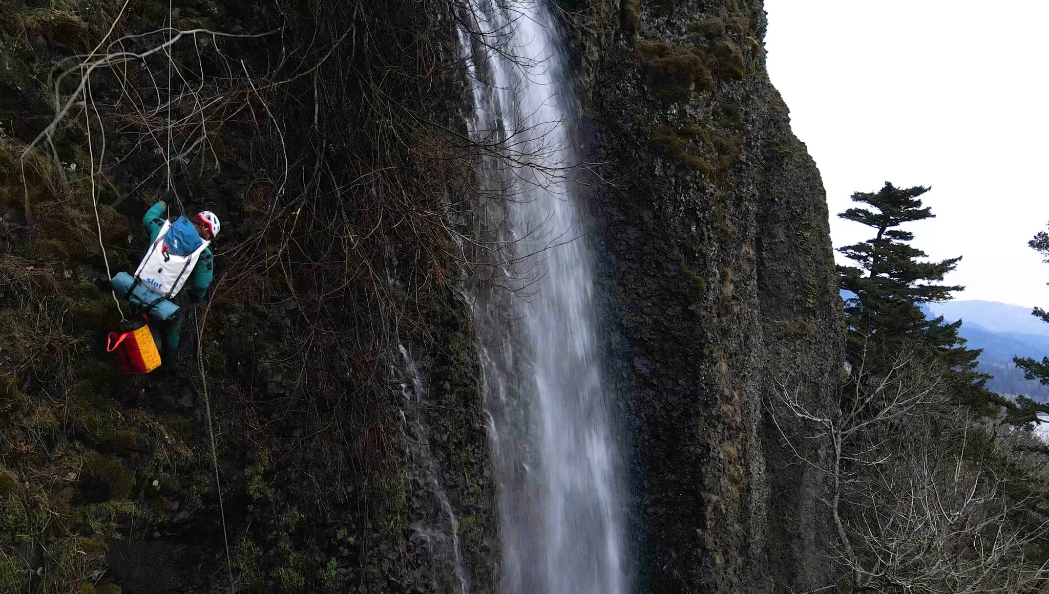 Rappelling a waterfall with a packraft