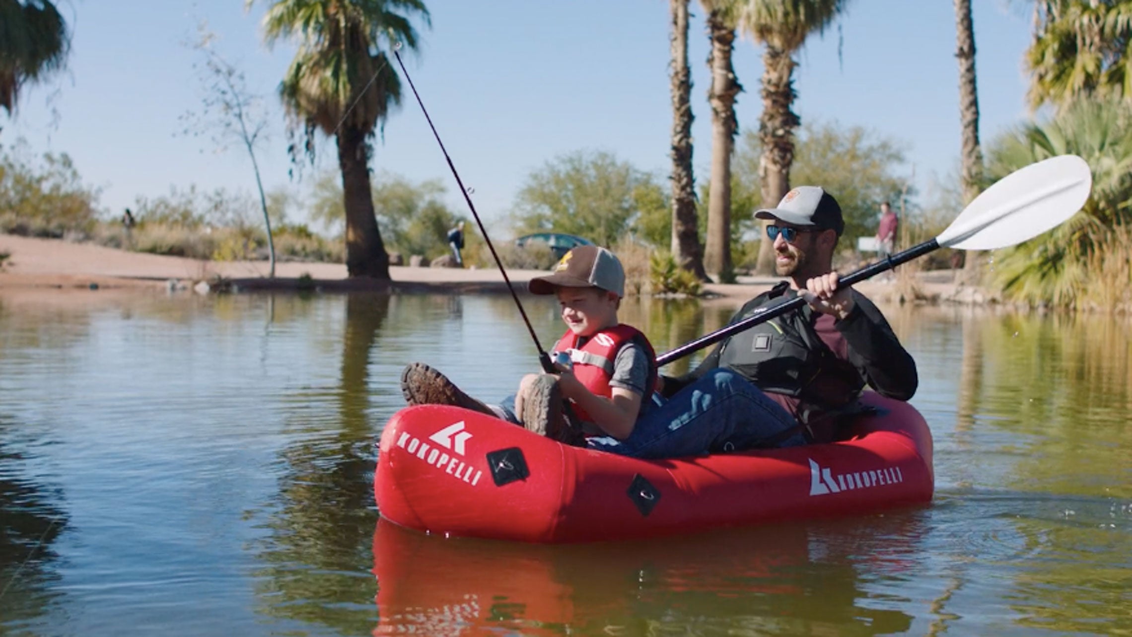 Father and son fishing in an XPD Kokopelli Packraft