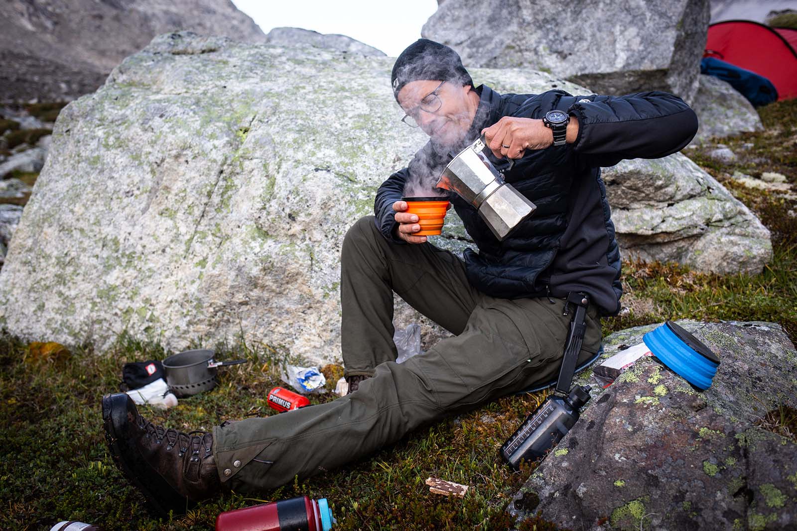 Taking a rest stop on the edge of the Tasermiut Fjord with a cup of coffee