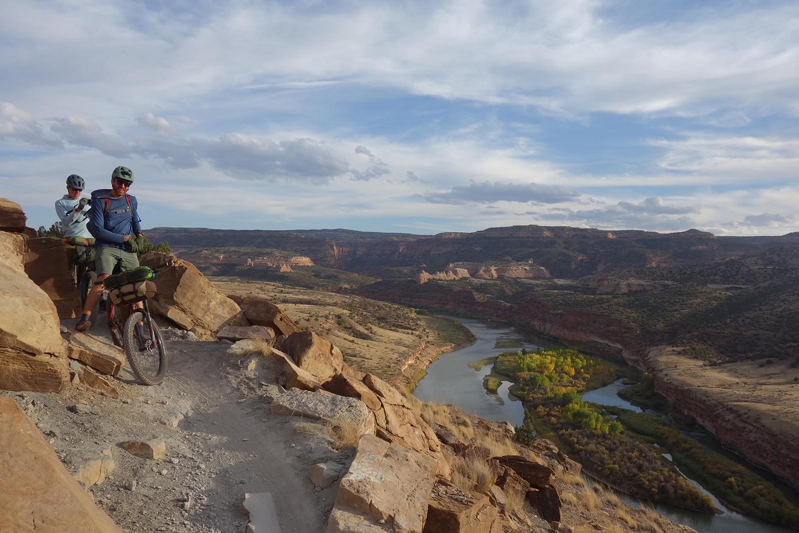 Bikerafting the American West - Two cyclists on overlook of Colorado River