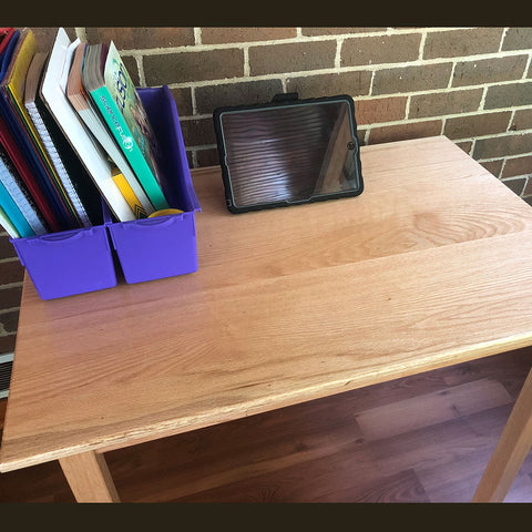 Handmade wood desk with school work and tablet on display