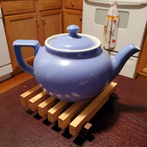 Wood Trivet with blue teapot on top