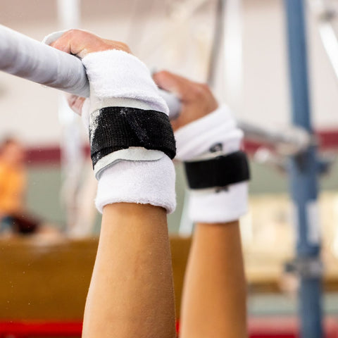 Gibson Athletic High Bar Grip on male gymnast's hands on high bar