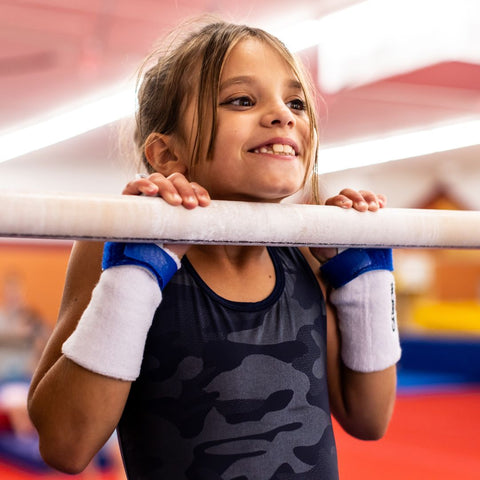 young gymnast on bar smiling