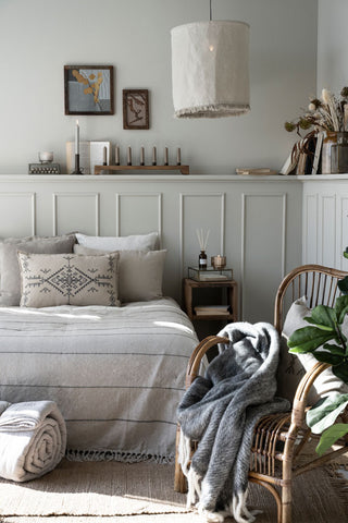 alt="Scandinavian style bedroom styled with throws"