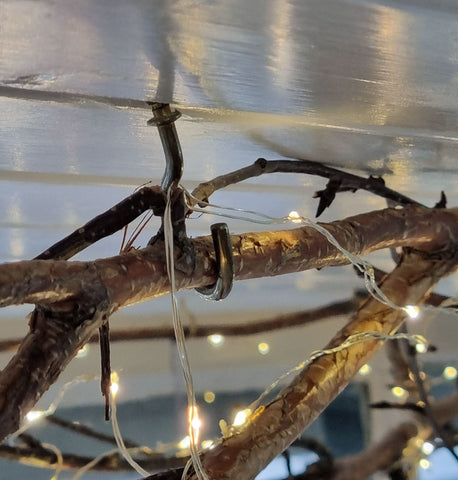 Fixing The Branch Into Place With Brass Screw Hooks