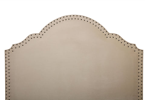 alt="fabric covered headboard with shaped detailing to the top"