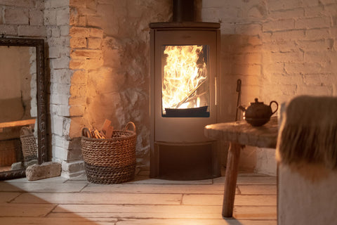 alt="Nordic style wood burning stove on a dark evening"