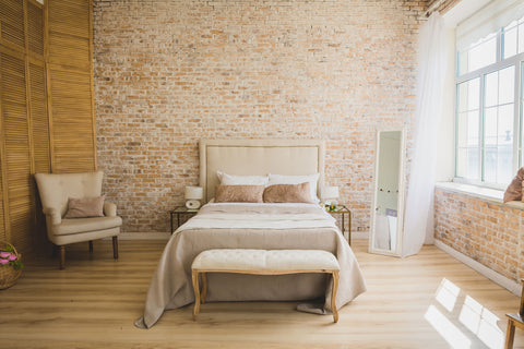 alt=" Loft style bedroom featuring a headboard"