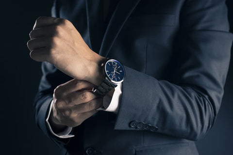 Man in a suit checking watch