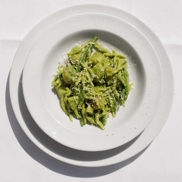 Trofie pasta coated in bright green pesto with a sprinkling of parmesan.