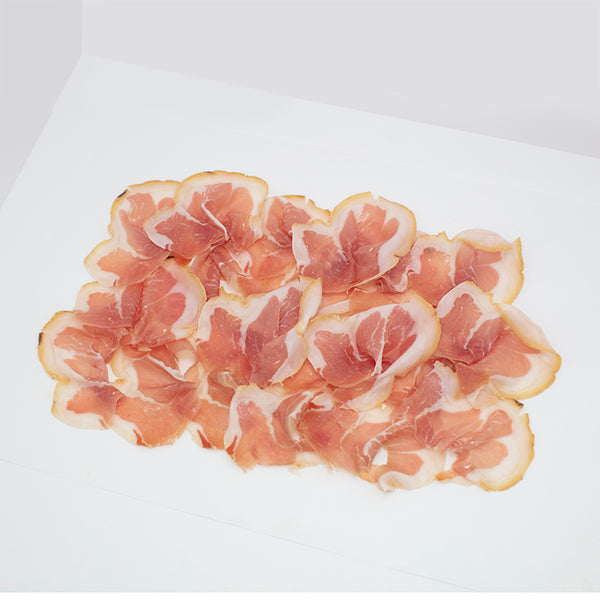 Thinly sliced Culatello di Zibello on wax paper