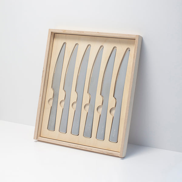 A set of six stainless steel steak knives in a wooden presentation box.