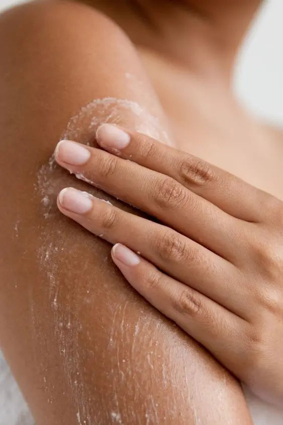 Woman exfoliating her arms