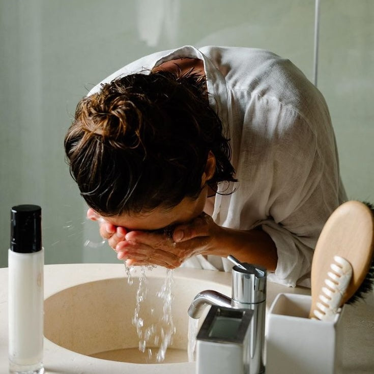 woman washing her face