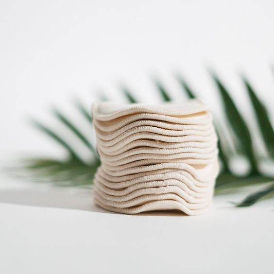 cotton pads with palm leaves in the background