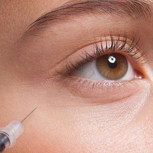 woman applying botox to her face