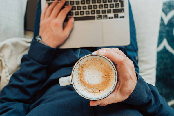 hand holding a coffee mug