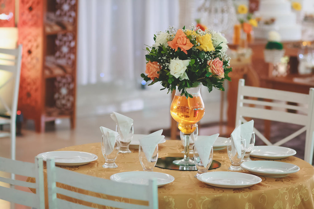 Printed Golden Tablecloth to Match the Dining room Theme,White China Dishes  and Czech Crystal Wine Glass to Show The Unique Taste The Rose Bouquets Added Different Style Also