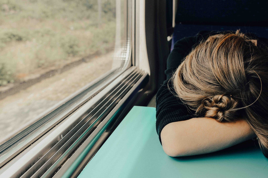 Mujer en un tren cansada porque no ha dormido bien durante la noche