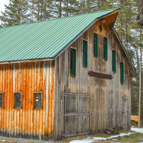 Wooden barn with sign "Little Creek"