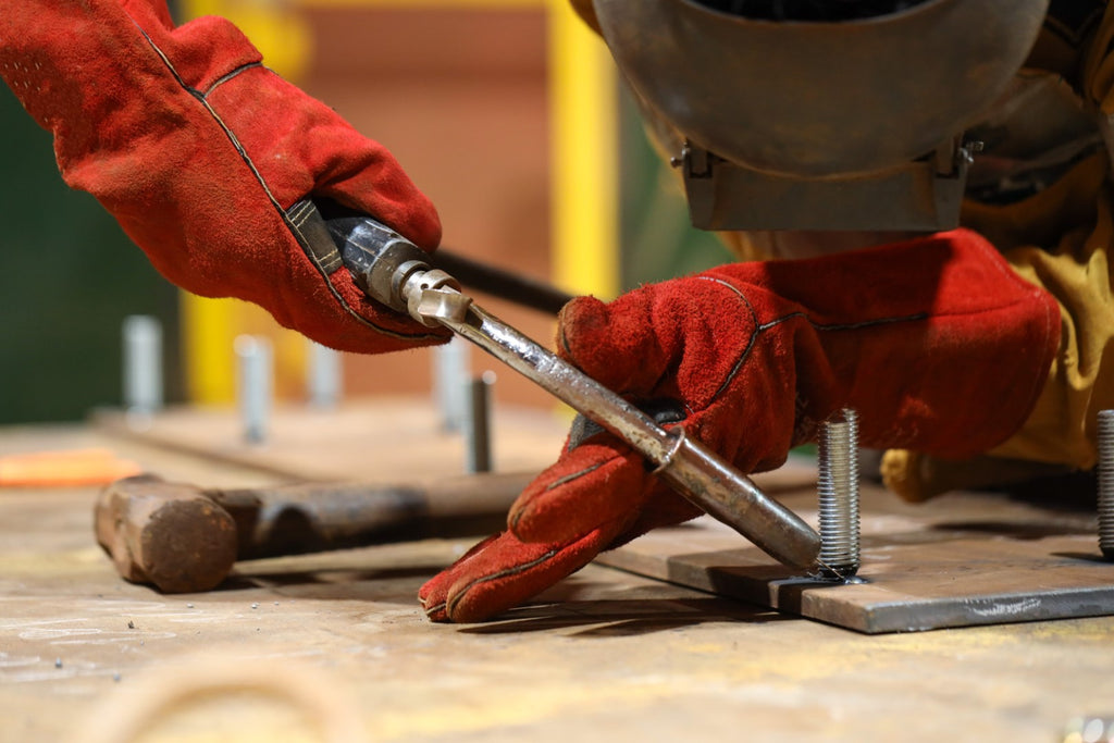 Welder working with gloves and a helmet