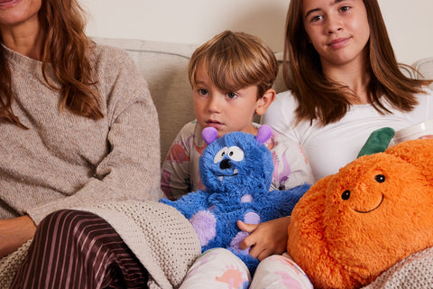 Children on sofa with Warmies soft toys