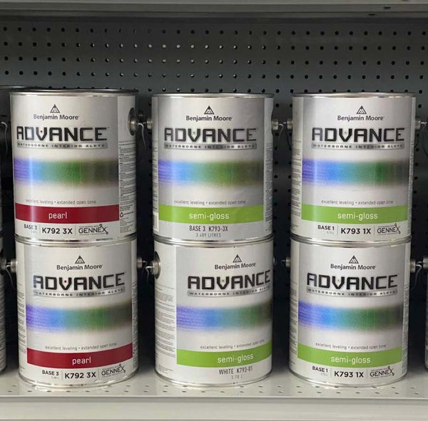 cans of Advance paint stacked on the shelves of a Benjamin Moore paint store