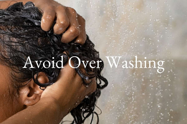 Women washing her curly hair and the words Avoid Over Washing placed on top the image by the Curly Life Company