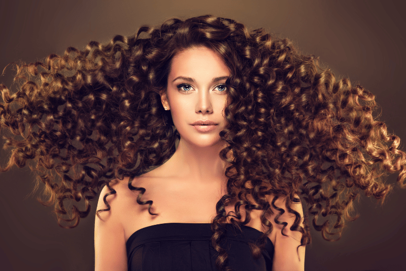 Beautiful woman with luxurious brown curly hair