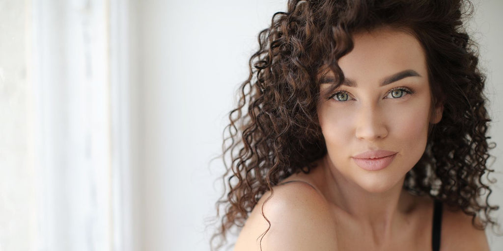 Beautiful Brunette with curly hair volume for days