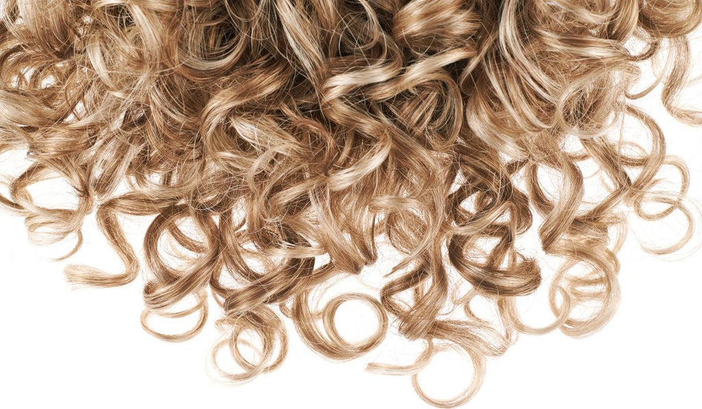 Blonde curly hair on a white background