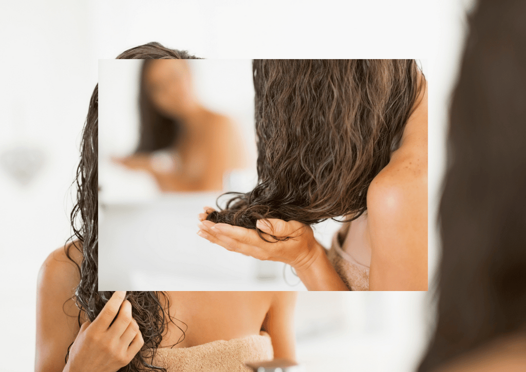 woman in mirror inspecting her hair