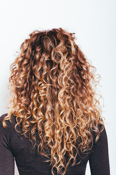 woman with curly hair showing from the back