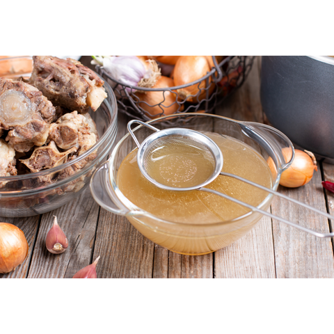 Bone broth being strained, recipe