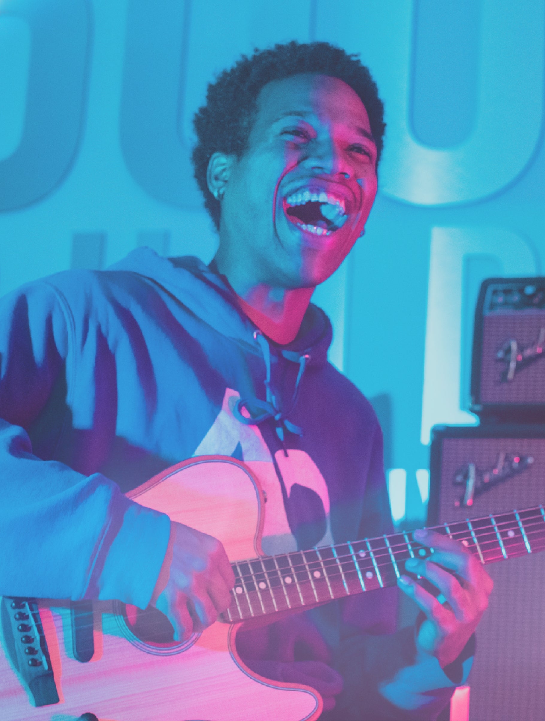 guy smiling holding a guitar