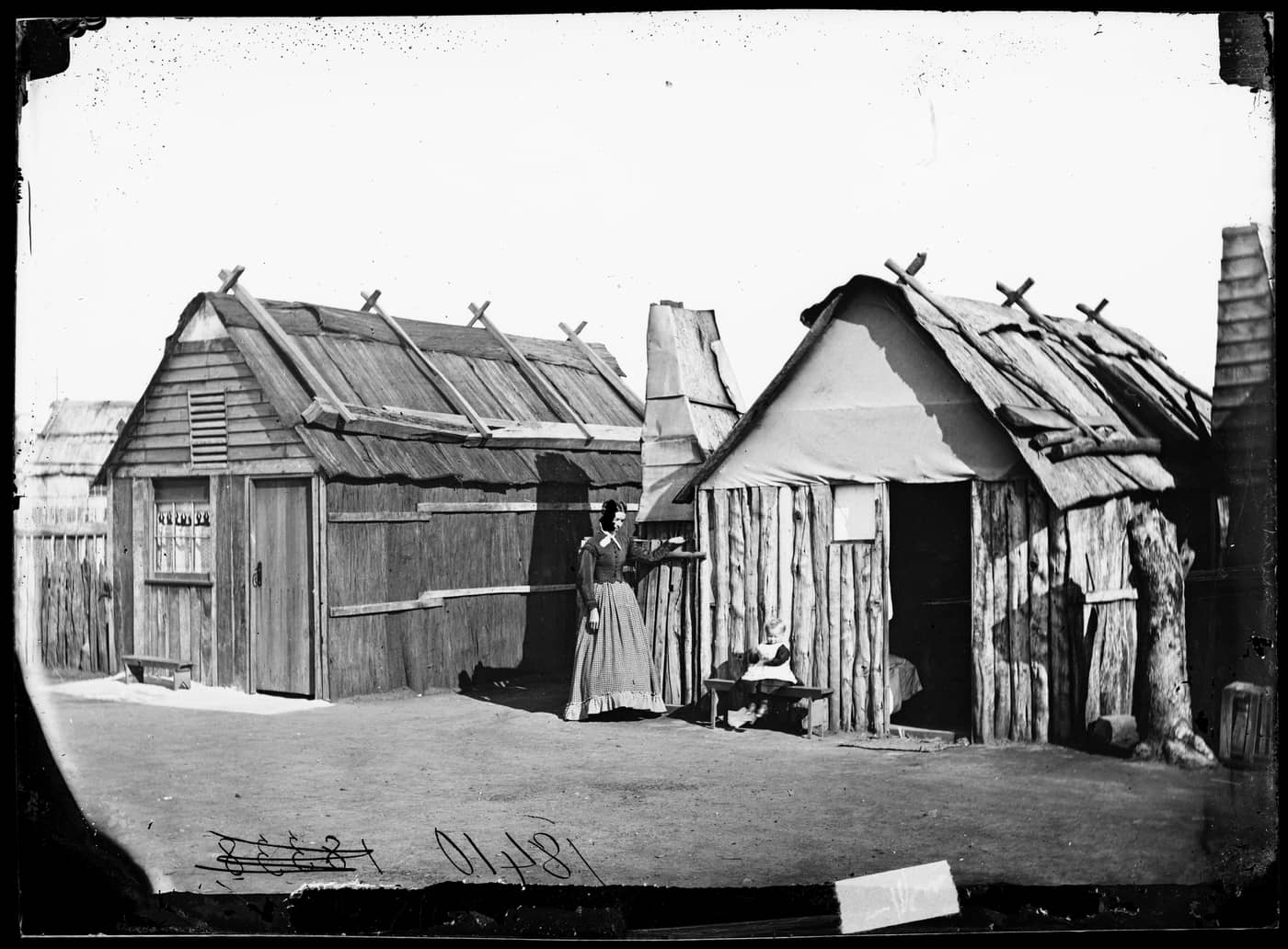 Louisa Lawson and her son Charles William in front of their bark hut, Gulgong area