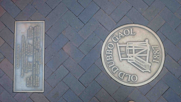 Old Dubbo Gaol - Central West NSW - Bronze sign embedded in footpath with Gaol logo tourist attraction 