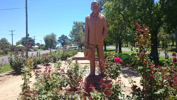 Henry Lawson Statue amongst Rose garden in Gulgong NSW