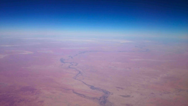 Aerial photography of Outback Australia Northern Territory near Darwin. Red Earth, scrub fires, rivers and raods carving through desolote terrain