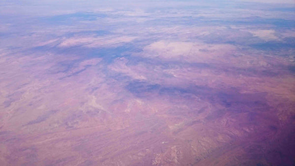 Aerial photography of Outback Australia Northern Territory near Darwin. Red Earth, scrub fires, rivers and raods carving through desolote terrain