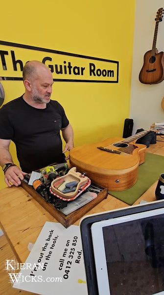 Luthier Rod McCracken measuring action on Kieran Wicks' Cole Clark Guitar Fat Lady 2 at The Guitar Room - Kilmore Victoria