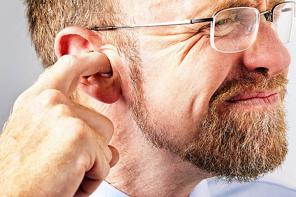 A person with excessive ear wax in their ear