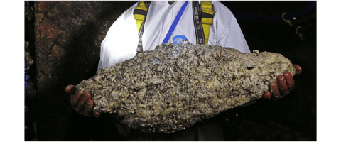 Woman holding fatberg caused by wet wipes