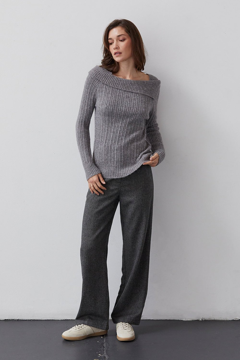 woman wearing gray sweater and charcoal trousers