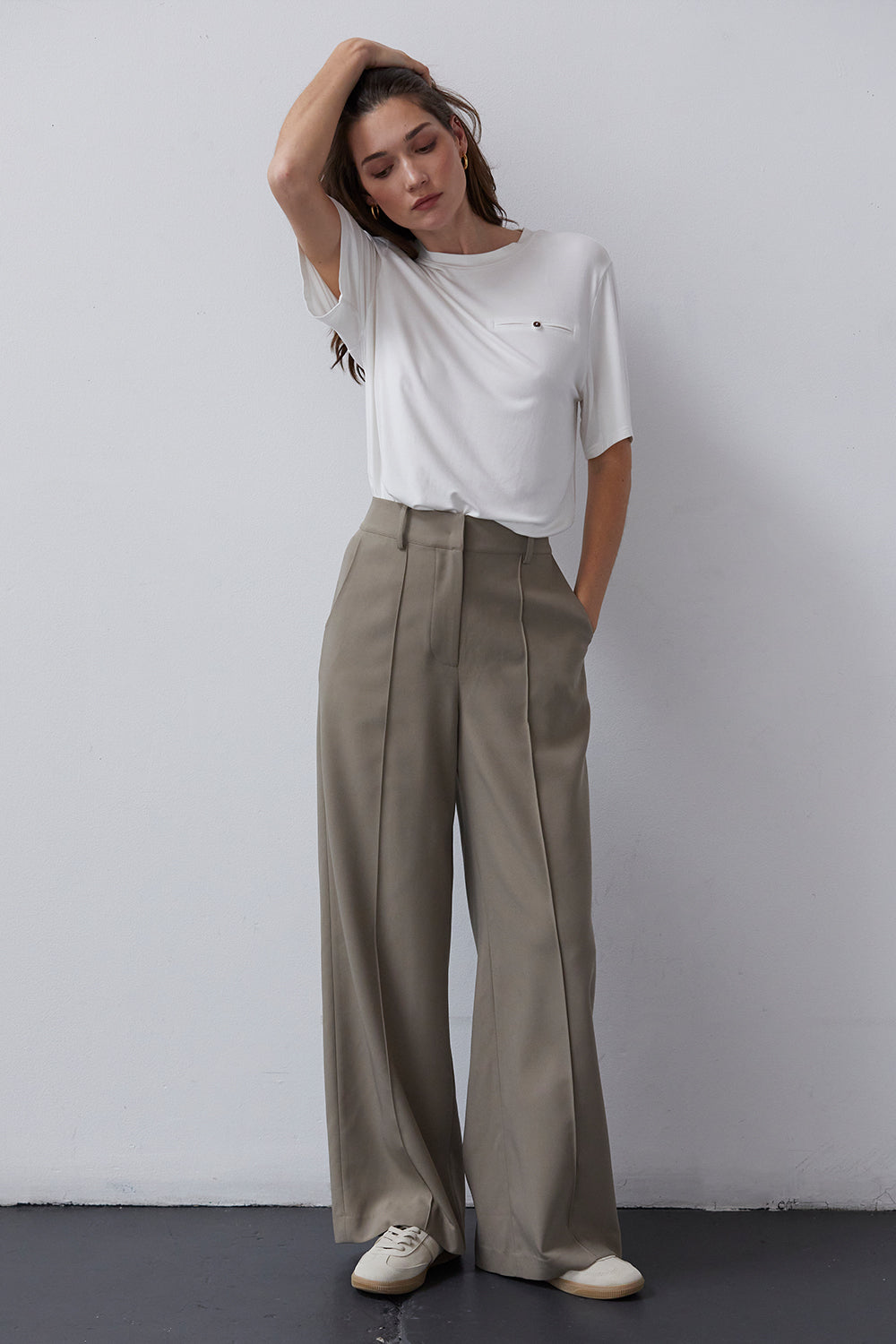 woman wearing wide pants and white tee shirt capsule wardrobe essential