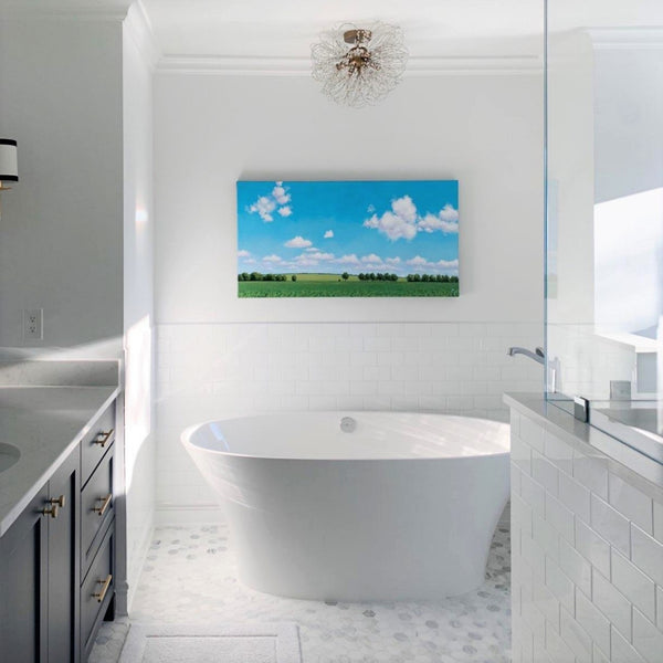 Landscape painting hanging over bath tub in high-end bathroom